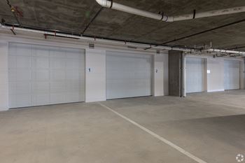 a large garage with white doors in a building at Aura Vegas Apartments, Las Vegas